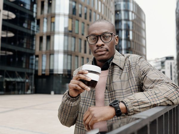 afro american man in the city with coffee