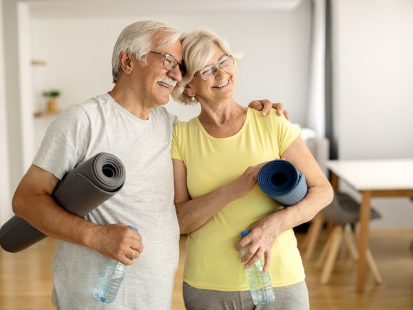 mature couple with yoga rugs