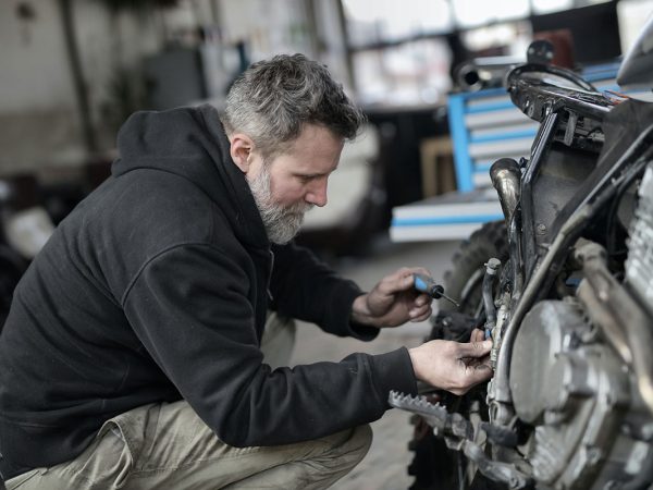 man fixing car testosterone and hair loss treatment